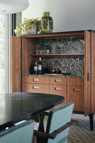 A drinks cabinet in walnut with marble interior
