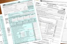 2025 tax year IRS 1040 individual and schedule C profit or loss from business tax forms lay on a desktop.