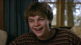 Leonardo DiCaprio smiles in mid conversation at the dinner table in Whats Eating Gilbert Grape.