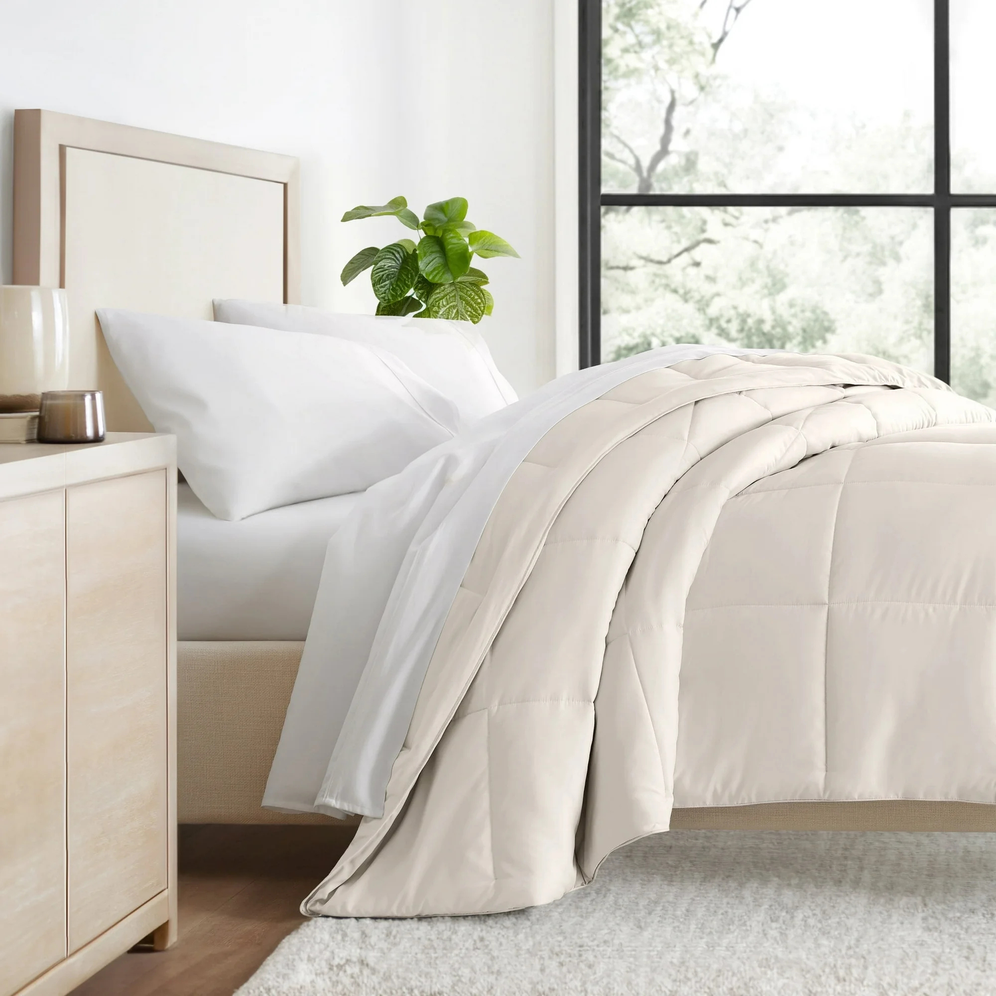 A beige quilted bedspread from Walmart