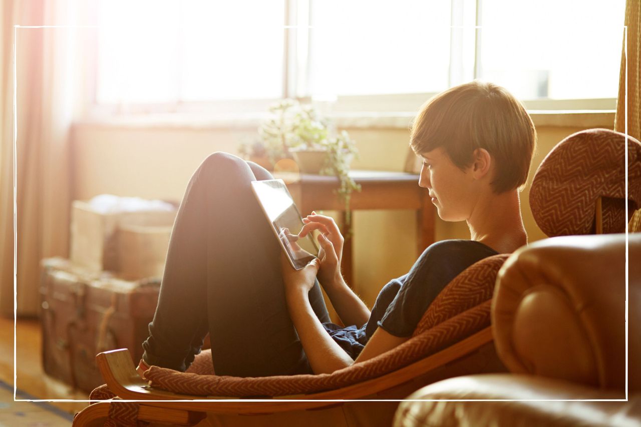 Young woman relaxing at home with a tablet