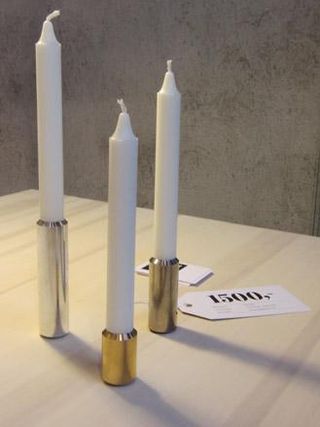 A set of 3 candles on a wooden table