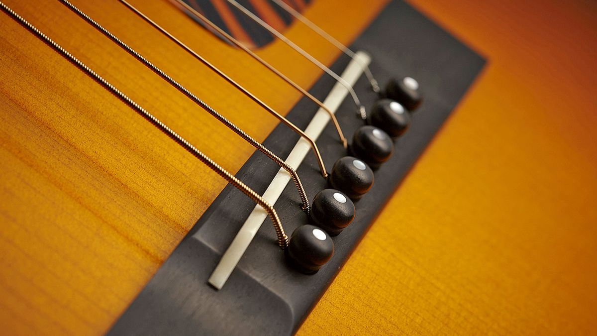 It's a lot of work to put in a cut-through bone saddle like this. Notice how it's shaped for intonation compensation