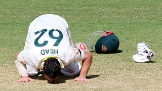 Australia's Travis Head kisses the Adelaide Oval pitch after scoring a century during the Ashes 3rd Test