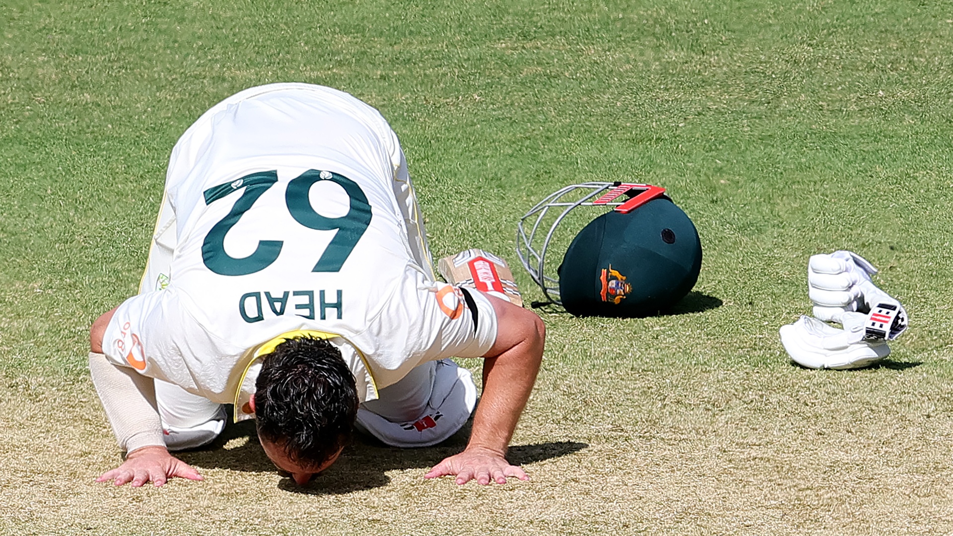 Australia's Travis Head kisses the Adelaide Oval pitch after scoring a century during the Ashes 3rd Test