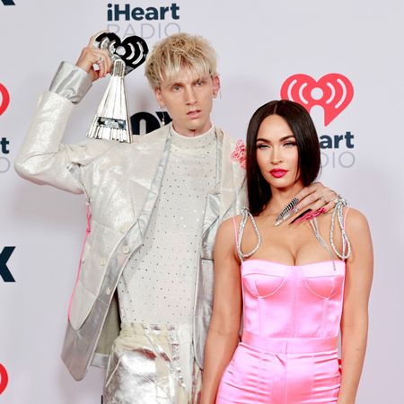 Machine Gun Kelly, winner of the Alternative Rock Album of the Year award for 'Tickets To My Downfall,’ and Megan Fox attend the 2021 iHeartRadio Music Awards