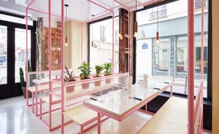 pink barred benches with large windows offer a view of the outside street