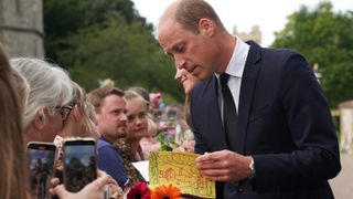 Britain's Prince William, Prince of Wales chats with well-wishers on the Long walk at Windsor Castle on September 10, 2022