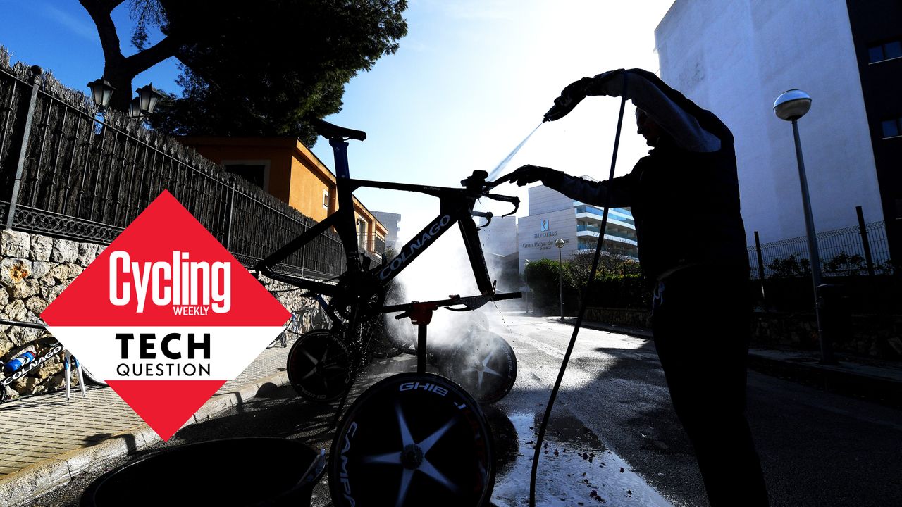 Mechanic washes a bike on team training camp