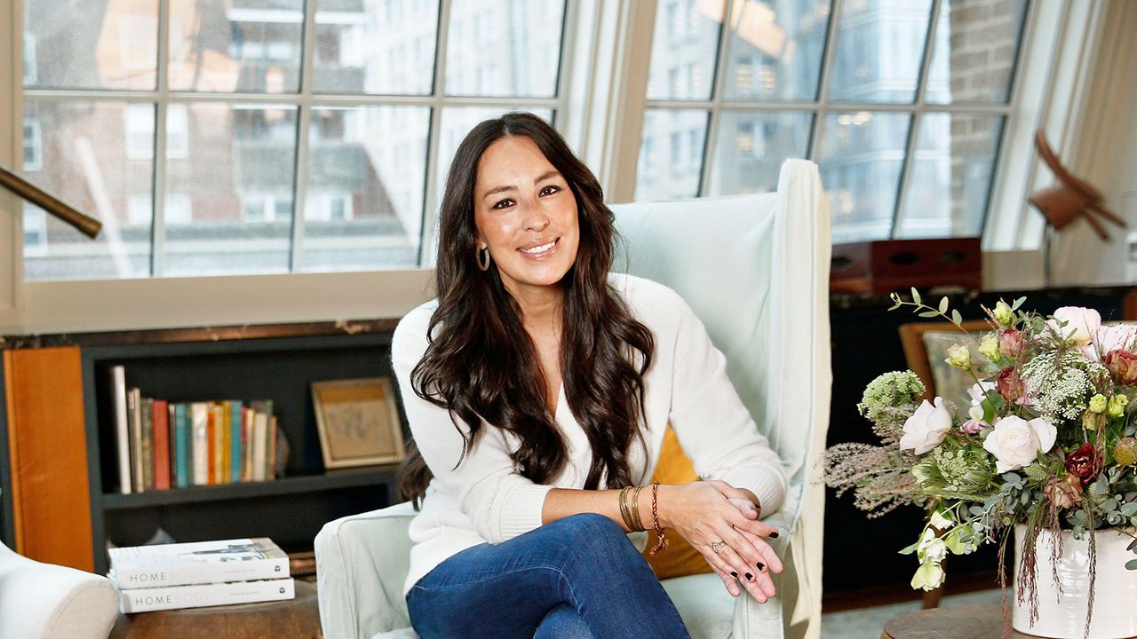 Joanna Gains sits in armchair