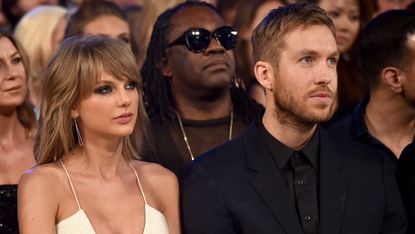 Taylor Swift and Calvin Harris sit side by side at an awards show.