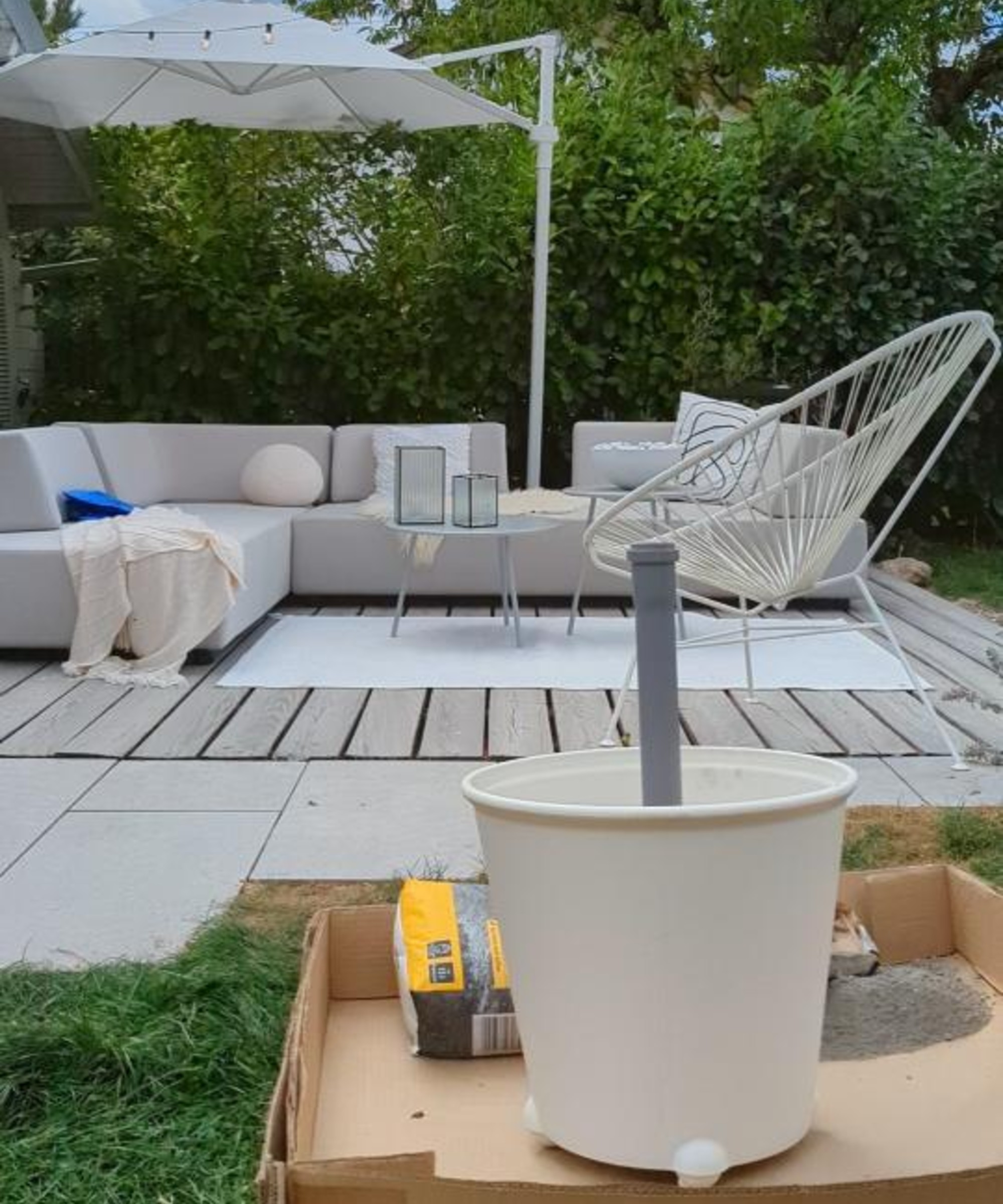 A garden parasol stand and side table on wheels being made with an IKEA planter
