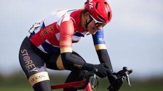 Dame Sarah Storey, wearing a red cycling helmet, races on her bike ahead of the Road Cycling at Paralympics 2024 