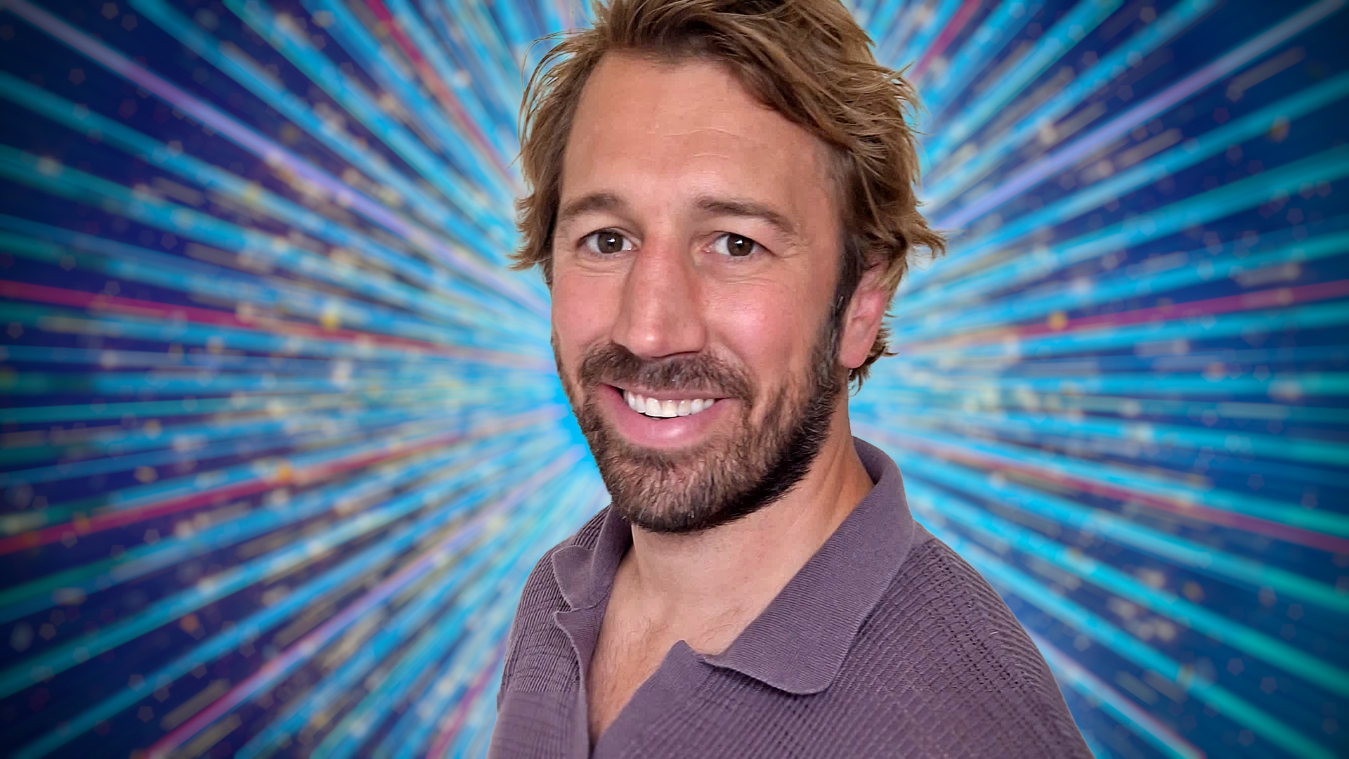 Chris Robshaw smiling for the camera with a blue sparkly background behind her.