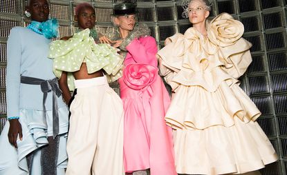 Models wear ruffled dresses in beige, pink, green and blue with knits