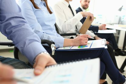 Employees sitting down with retirement documents