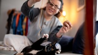 Woman playing with cat