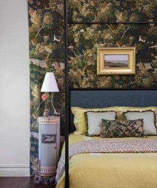 bedroom with dark patterned wallcovering behind bedhead