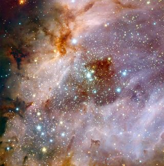 Astronomers using data from ESO's Very Large Telescope created this composite photo of the nebula Messier 17, also known as the Omega Nebula or the Swan Nebula. The image shows vast clouds of gas and dust illuminated by the intense radiation from young st