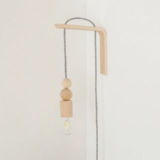 A wooden pendant wall light