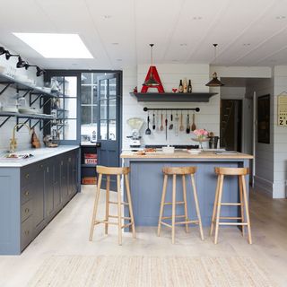 kitchen with grey cabinet and wooden bar stools