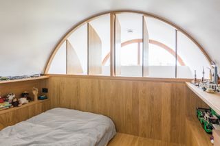 timber clad mezzanine bedroom with windows for privacy