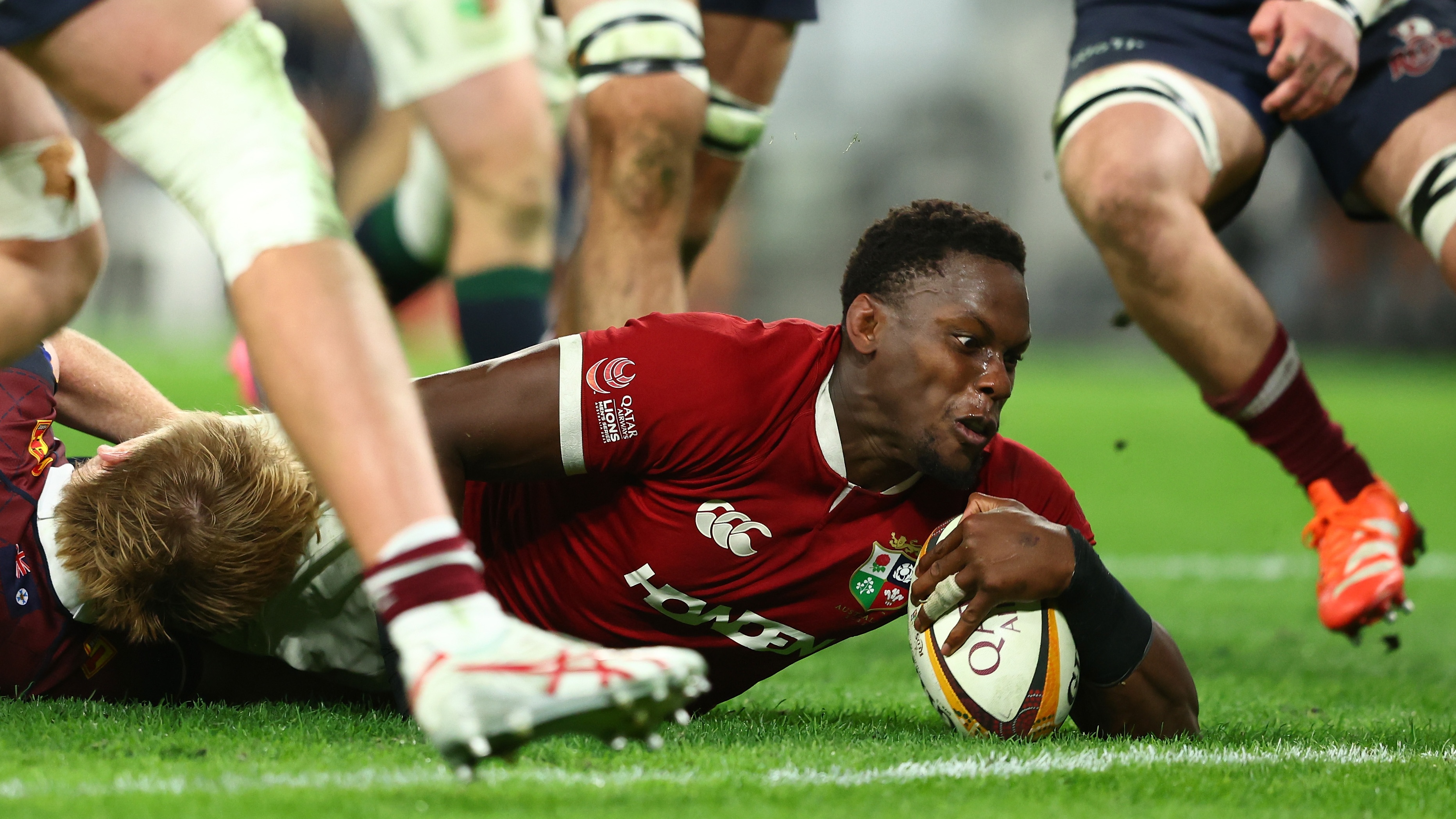 Maro Itoje reaches for the try line in a Lions fixture against Queensland Reds.