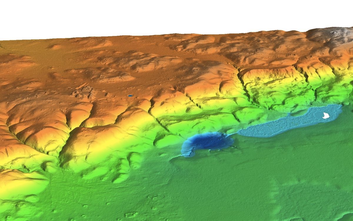 A lidar survey shows the entire ceremonial center stretching for 1.2 miles (2 kilometers) along a limestone ridge overlooking Laguna Ek&#039;Naab (white spot), the sampling site for the paleoenvironmental study on the Maya.