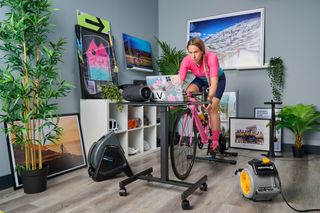 A female cyclist rides indoors