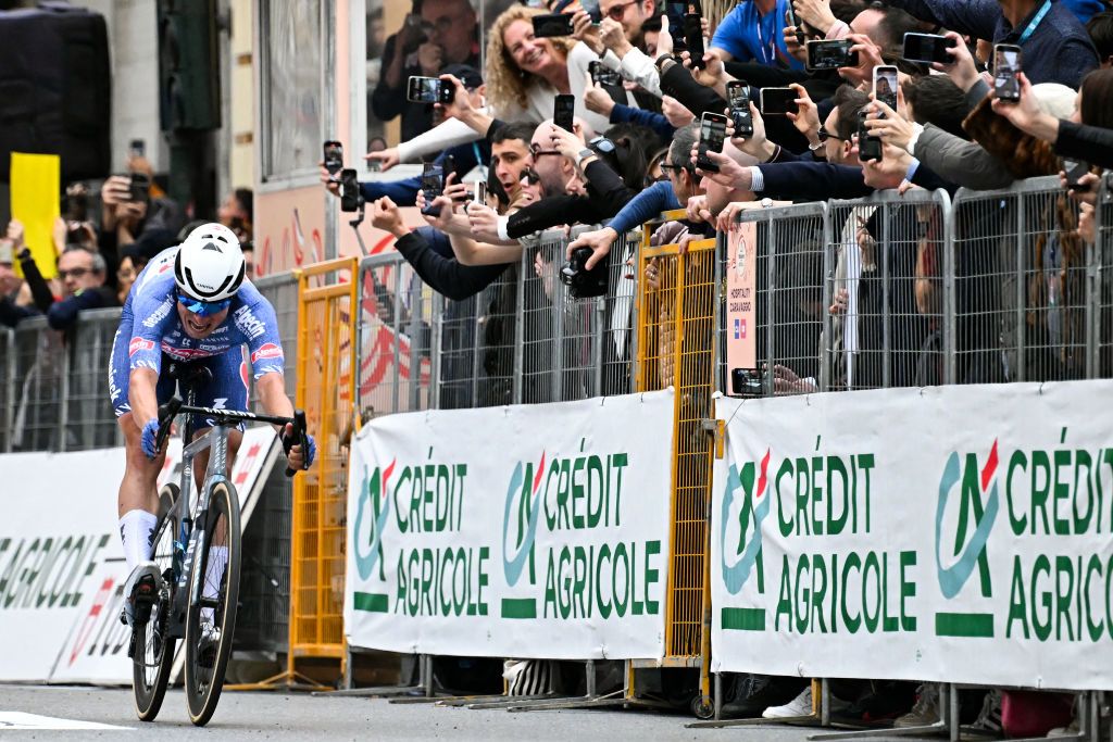 Alpecin-Deceuninck's Belgian rider Jasper Philipsen crosses the finish line to win the 115th Milan-SanRemo one-day classic cycling race, between Pavia and SanRemo, on March 16, 2024. (Photo by Marco BERTORELLO / AFP)
