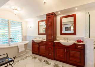 white bathroom with bathtub and table top washbasin