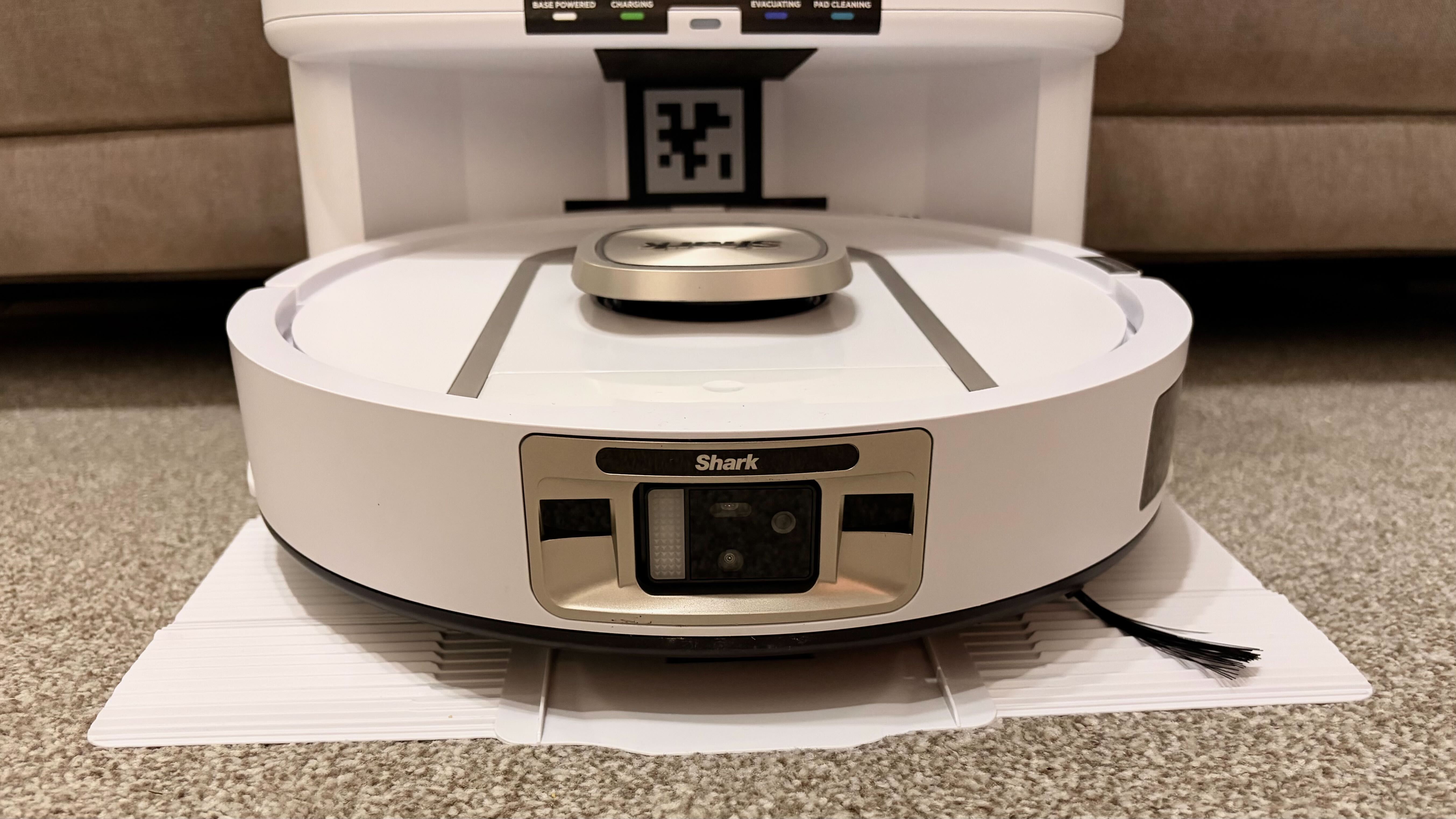 Shark PowerDetect 2-in-1 ThermaCharged NeverTouch photographed on a carpet with docking station