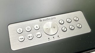 A close-up view of the Audio Pro Addon C10 MkII wireless speaker's control panel. There are buttons for power, playback control, Bluetooth pairing and volume. Six numbered buttons can be used for shortcuts to your favorite music.