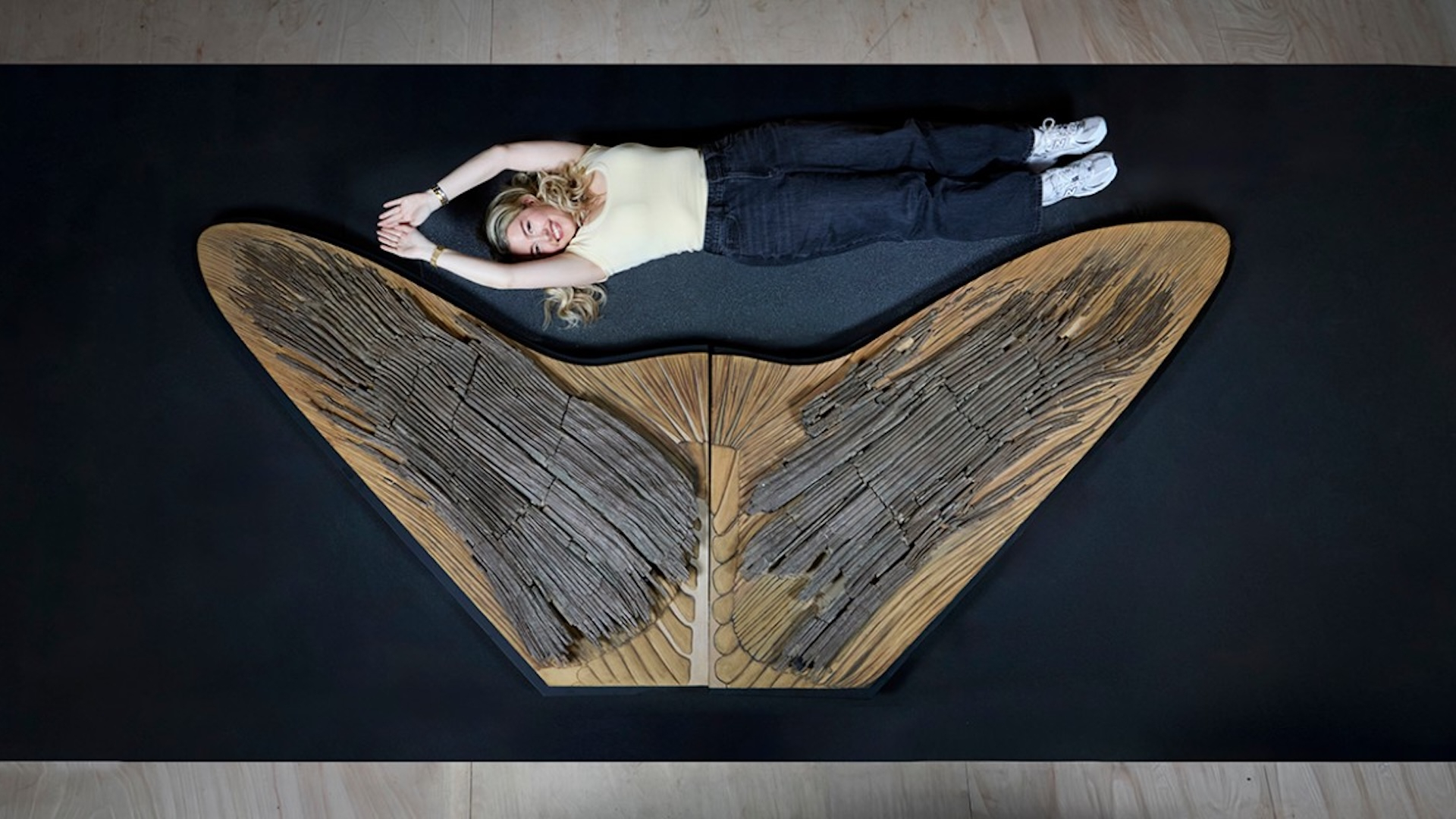 A lady laying down with a fin next to her 