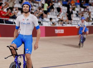 Italys Filippo Ganna celebrates after winning gold and setting a new World Record in the mens track cycling team pursuit finals during the Tokyo 2020 Olympic Games at Izu Velodrome in Izu Japan on August 4 2021 Photo by Odd ANDERSEN AFP Photo by ODD ANDERSENAFP via Getty Images