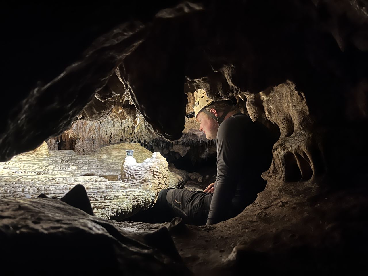 a man works in a dark cave