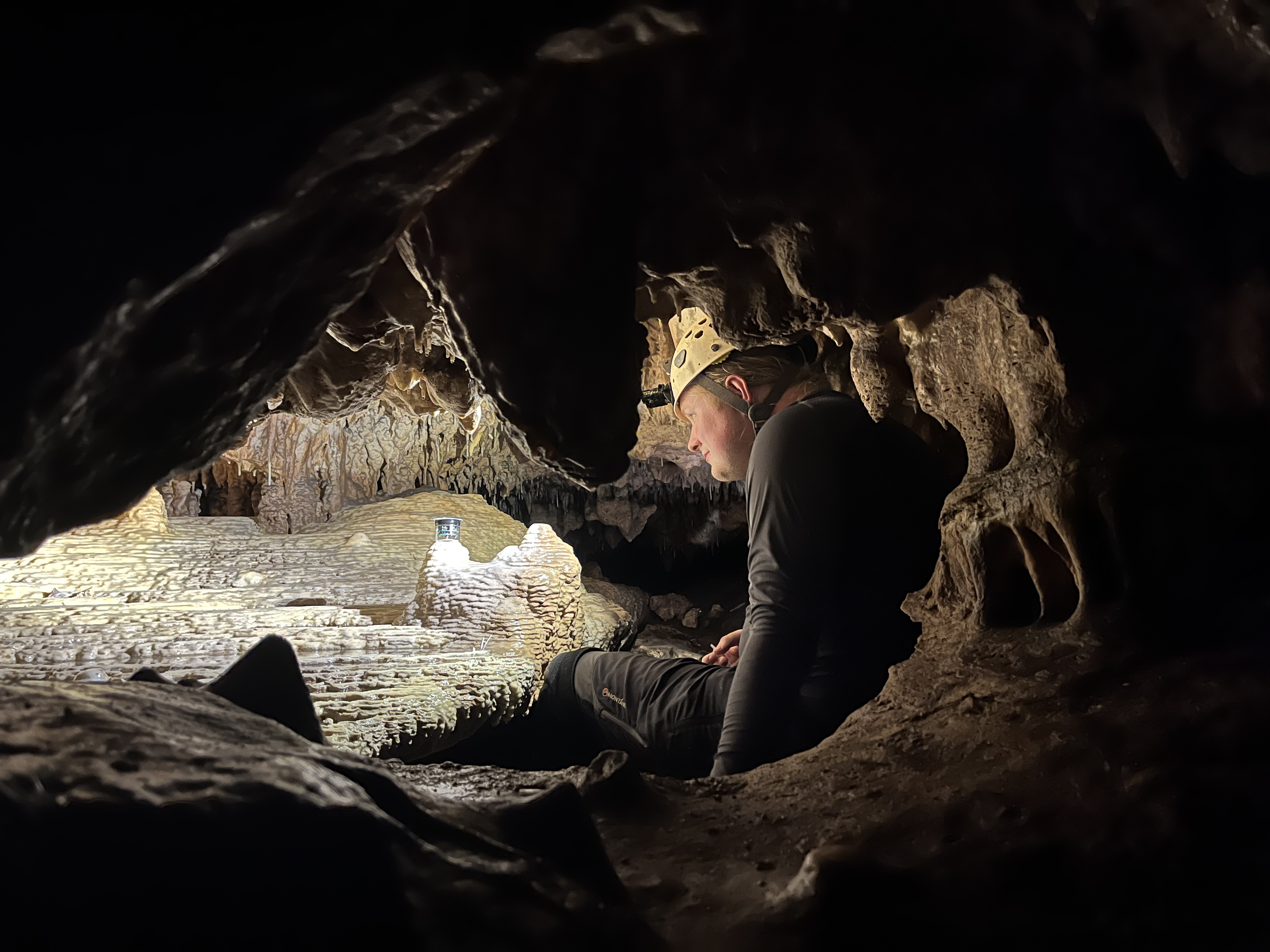 a man works in a dark cave