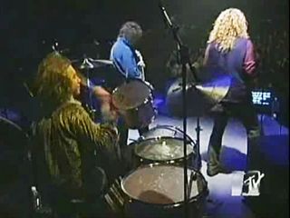Michael Lee, seen here performing with Jimmy Page and Robert Plant for MTV in 1994