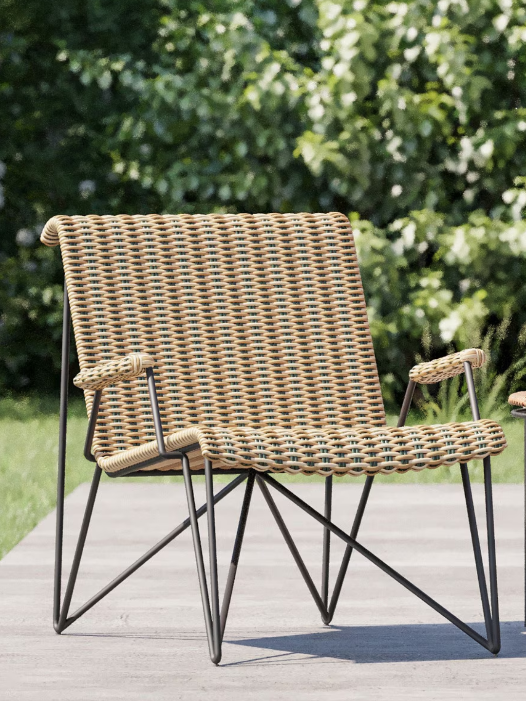 A rattan outdoor chair with structural base