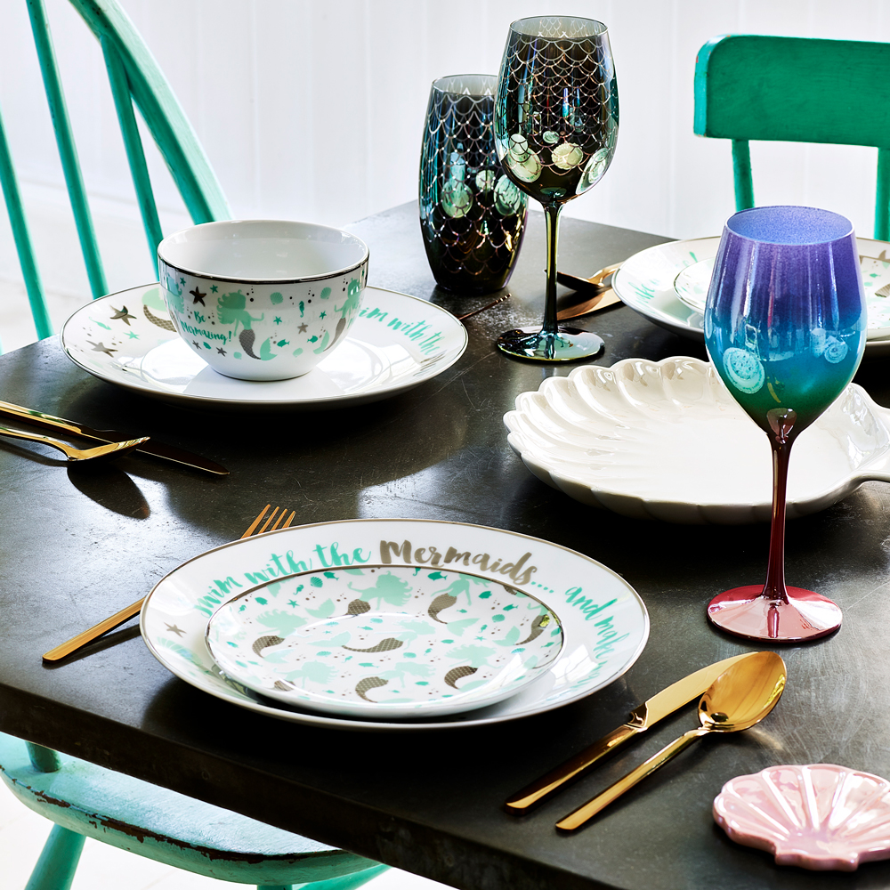 dark dining table with mermaid dinner set