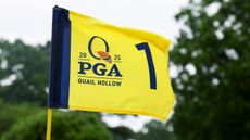 A yellow PGA Championship 1 flag flapping in the wind