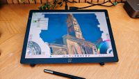 A drawing tablet on a wooden desk