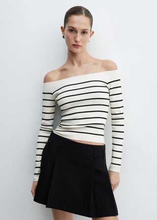 Model wears striped Off-The-Shoulder Knitted Sweater with short black skirt 