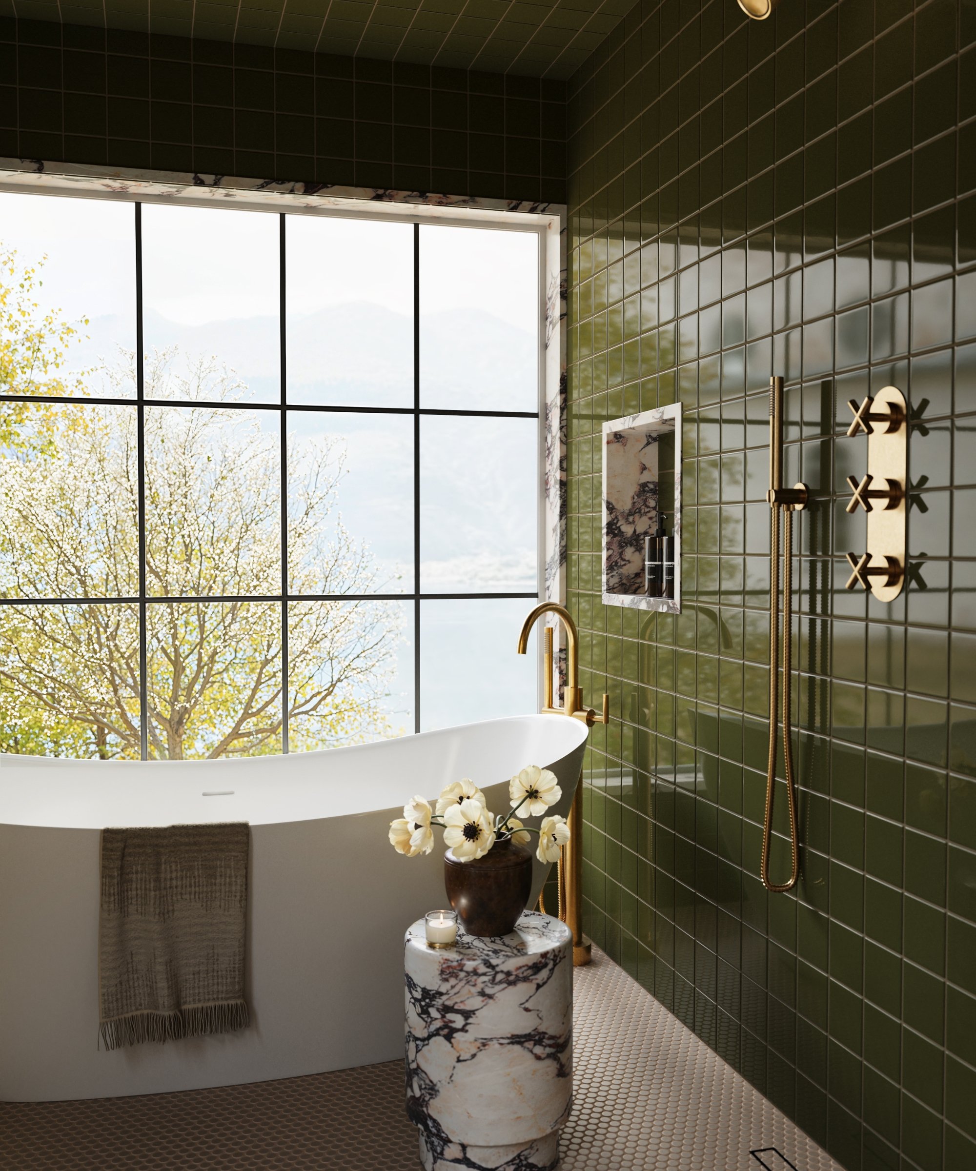 A wet room with green tiled walls, a large window, brass hardware, and a freestanding bath