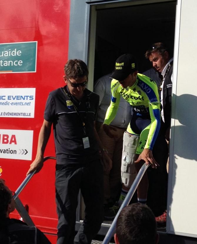 Team staff help Alberto Contador (Tinkoff-Saxo) down the stairs from the medical station following his stage 10 crash