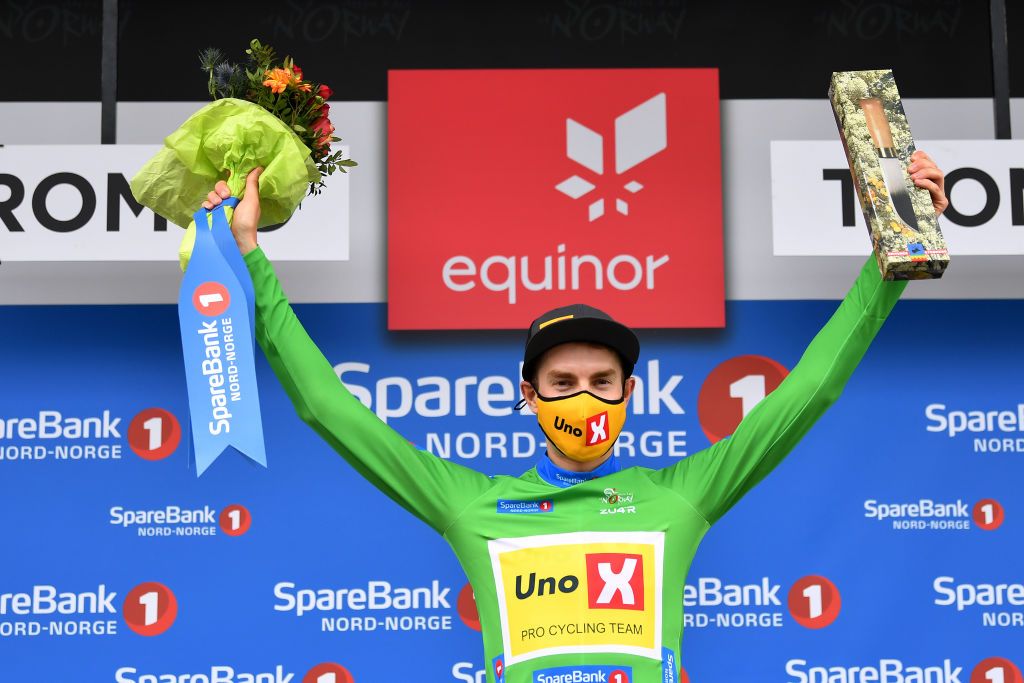 TROMSO NORWAY AUGUST 05 Markus Hoelgaard of Norway and UNO X Pro Cycling Team Green Points Jersey celebrates at podium as stage winner during the 8th Arctic Race Of Norway 2021 Stage 1 a 1425km stage from Troms to Troms ArcticRace on August 05 2021 in Tromso Norway Photo by Stuart FranklinGetty Images