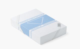 View of a blue and white Prada Timecapsule box pictured against a light coloured background