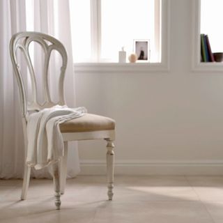 white wall with porcelain tiles and chair with curtain