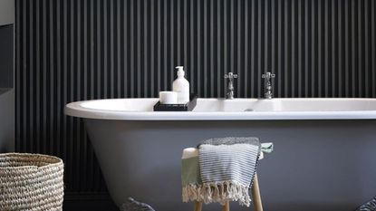 bathroom with bathtub and wall tiles