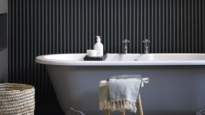 green panelled bathroom with tiled floor